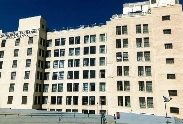 After: Rear of building painted cream with restored windows.
